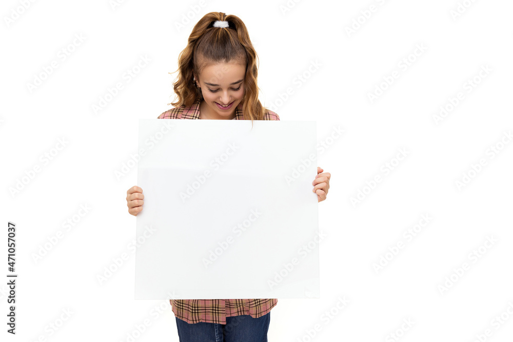 Fototapeta premium Photo of beautiful amazing cute adorable brunette teenage girl with ponytail in stylish plaid jacket, white t-shirt and holds white blank sheet isolated on white background with free space for text