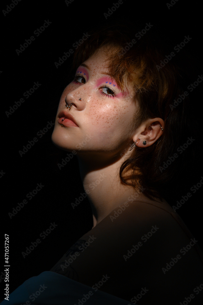 Portrait of Asian girl teen with anime cosplay makeup and freckles. Shadows and light in darkness Portrait of Asian girl teen with anime cosplay makeup and freckles. Shadows and light in darkness