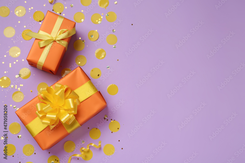 Orange gift boxes and confetti on lilac background, flat lay. Space for text Orange gift boxes and confetti on lilac background, flat lay. Space for text