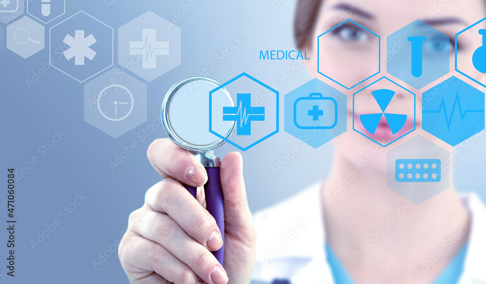 Woman doctor holding medical stethoscope and working with modern medical icons