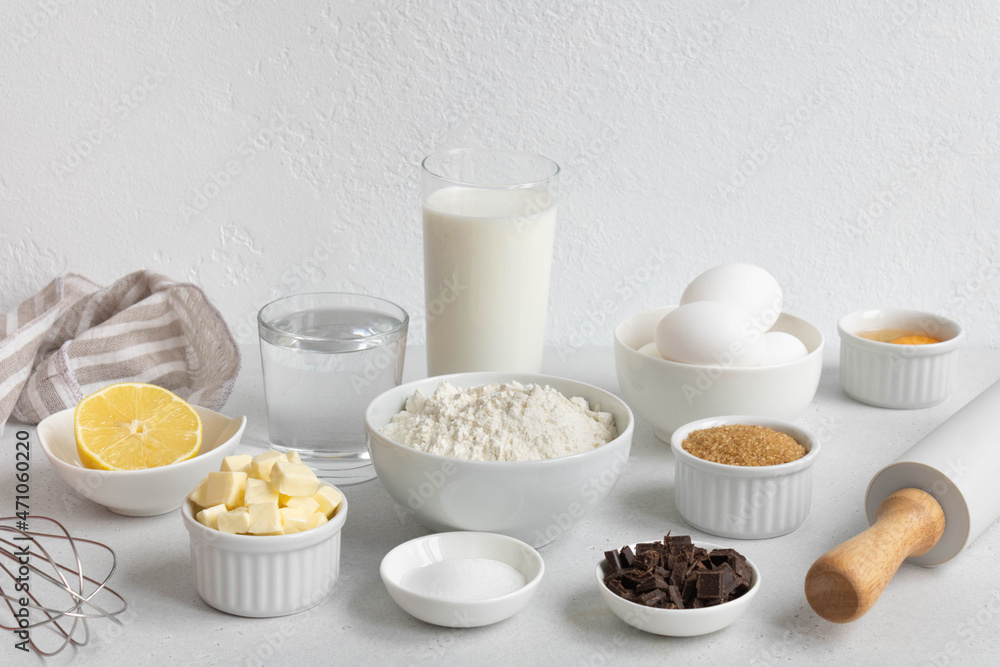 Ingredients for baking on a white background. Baking ingredients background. Ingredients for making dough, cakes, muffins, pies, side view. Ingredients for baking on a white background. Baking ingredients background. Ingredients for making dough, cakes, muffins, pies, side view.