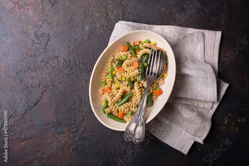 Bowl of Italian rotini pasta with vegetables