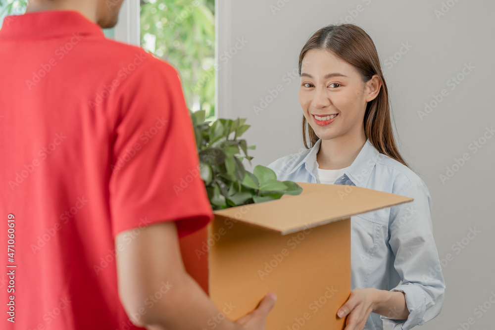 Happy, smile asian young pretty woman unpacking carton parcel, holding plant pot for interior before cargo company, delivery man, male packing cardboard box. Moving, preparing in new house, relocation Happy, smile asian young pretty woman unpacking carton parcel, holding plant pot for interior before cargo company, delivery man, male packing cardboard box. Moving, preparing in new house, relocation