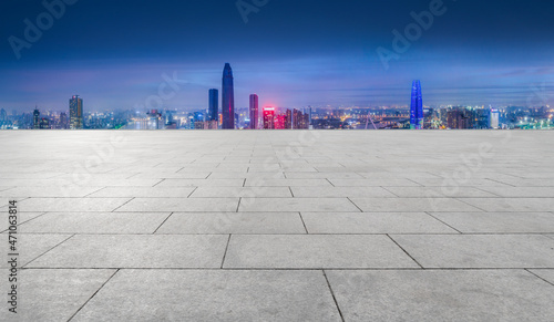 Empty brick floor with city skyline background