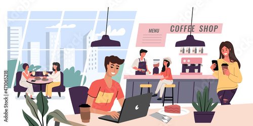 Young man sits at laptop in caffee shop. People drinking coffee and talking