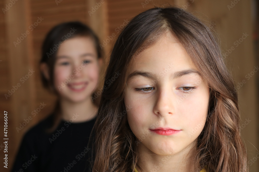 Emotional relationship of the sisters on the portrait. Envy, resentment and joy Emotional relationship of the sisters on the portrait. Envy, resentment and joy