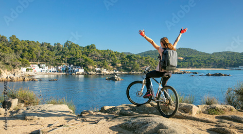 happy woman with bicycle enjoying beautiful view