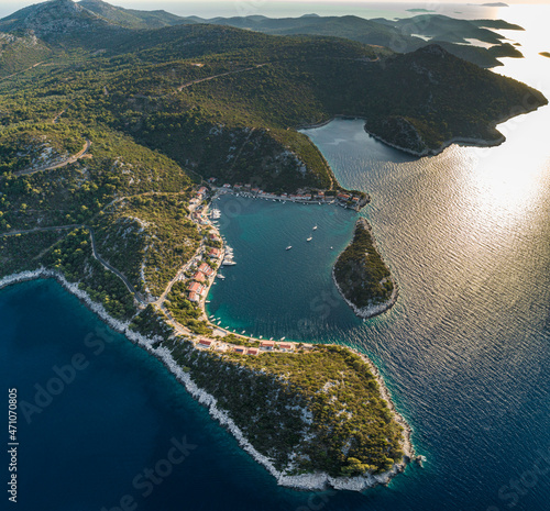 Aerial view of beautiful coastline in Zaklopatica town with a small bay and some sailing boats along the Mediterranean coast, Croatia. photo