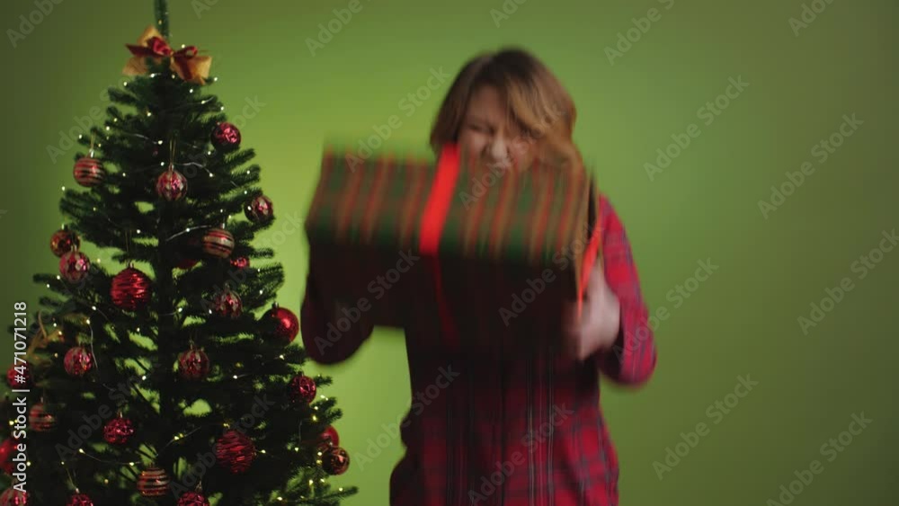A beautiful girl receives a gift. Emotions of delight, admiration, joy, happiness. Christmas sale concept. Shopaholic. A beautiful girl receives a gift. Emotions of delight, admiration, joy, happiness. Christmas sale concept. Shopaholic.