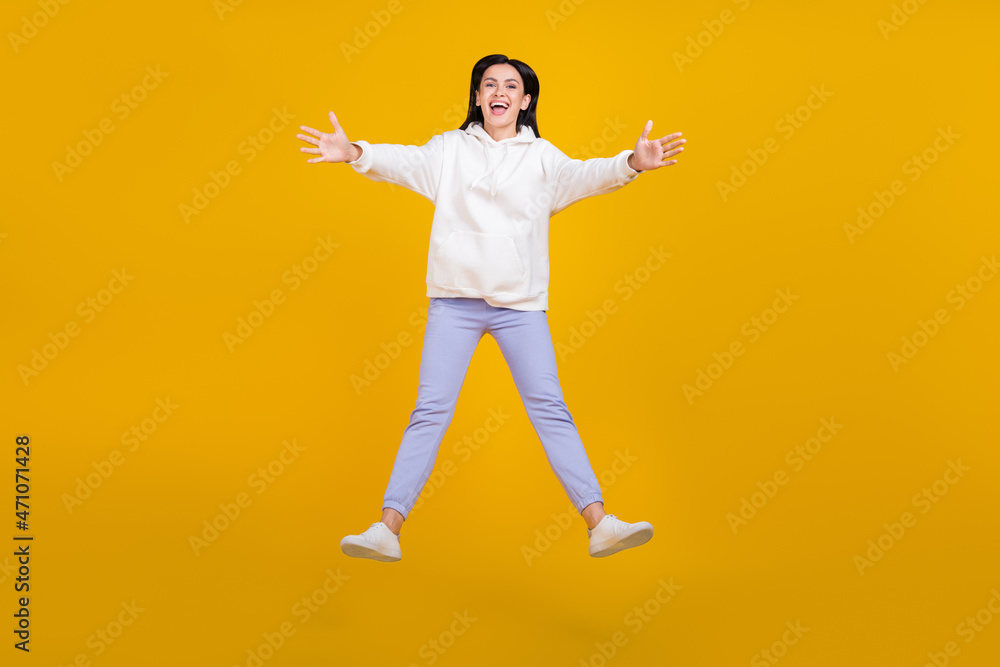 Full body photo of youngster lady jump cuddle best friend isolated over shine yellow color background