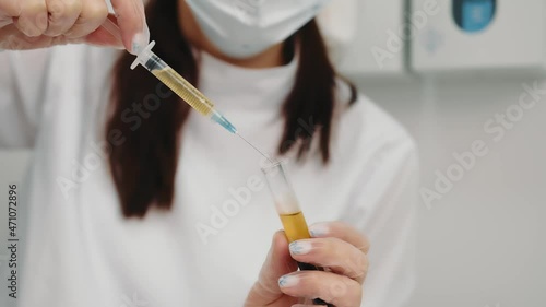 the doctor draws blood plasma into the syringe for further injection to the patient. photo