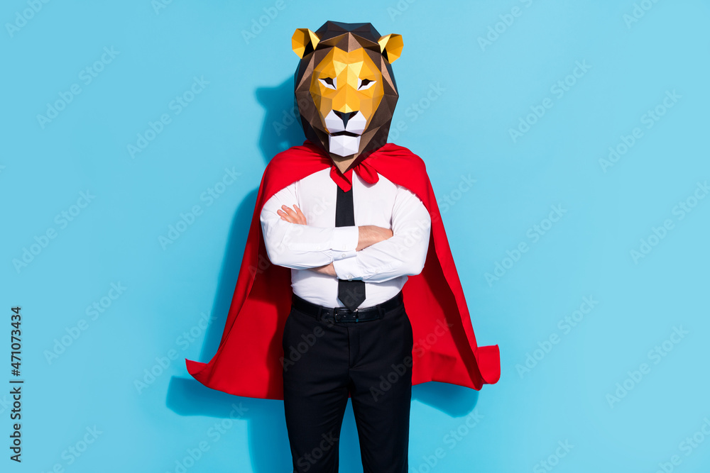 Photo of successful strong guy lion mask theme surreal occasion preparation isolated over blue color background Photo of successful strong guy lion mask theme surreal occasion preparation isolated over blue color background