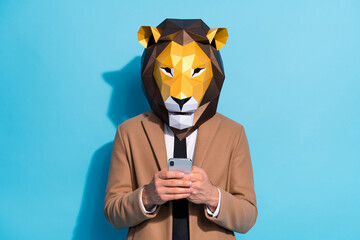 Photo of weird guy lion mask use smart phone texting halloween event invite theme send isolated over blue color background
