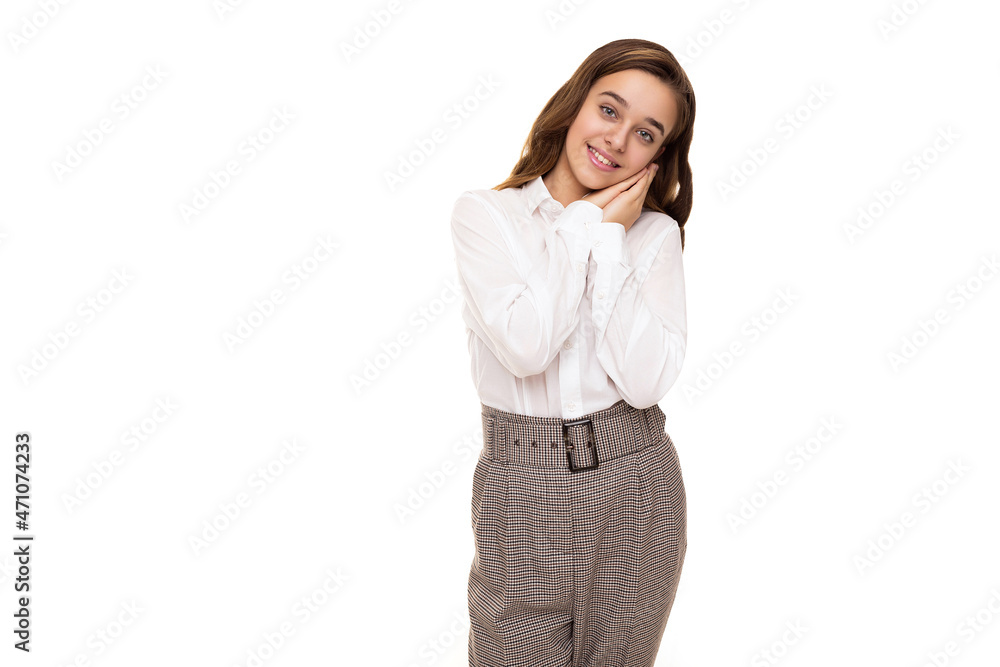 Photo of a beautiful and cute brunette girl with long hair in a white blouse and pants in a cage who smiles and stands isolated on a white background Photo of a beautiful and cute brunette girl with long hair in a white blouse and pants in a cage who smiles and stands isolated on a white background