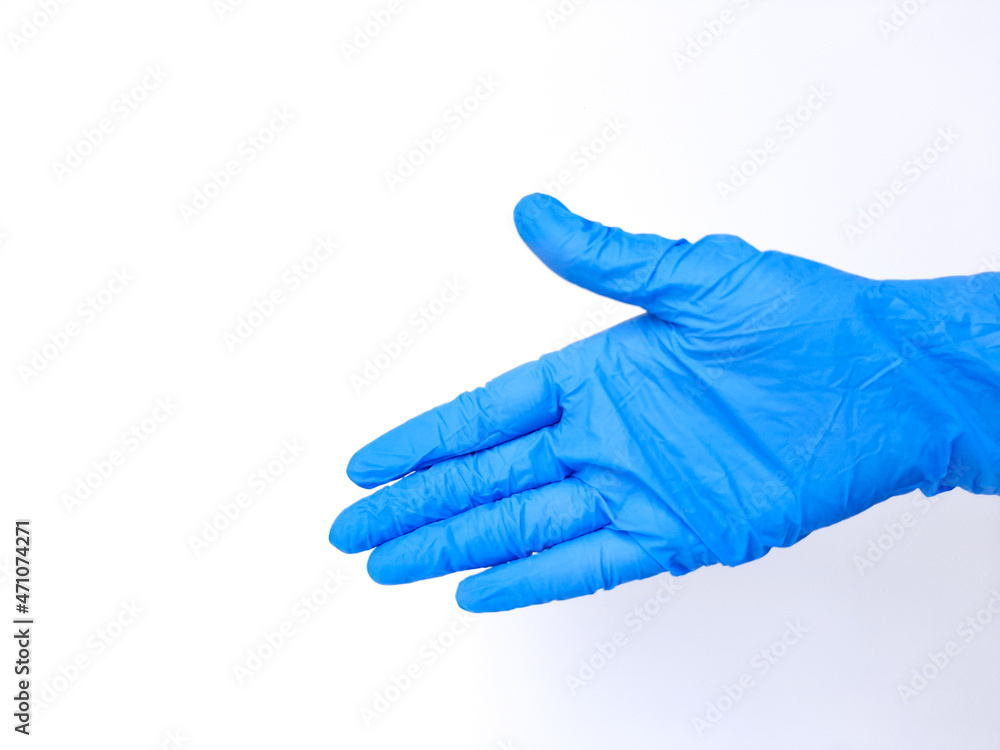 A hand with blue latex glove, request to handshake sign. Isolated on white background. Side view