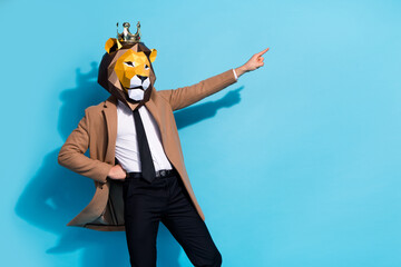 Photo of weird eccentric guy lion mask character point hand empty space offer theme event isolated over blue color background