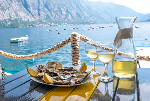 Oysters and white wine in a restaurant with a sea view photo