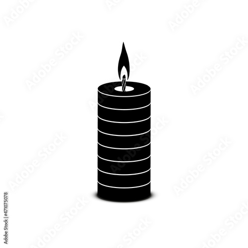 A burning paraffin candle of rectangular shape with rings on a white background.
