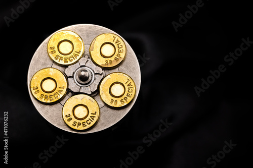 Fotografie, Obraz .38 special gun bullets with stainless revolver cylinder on black background , T