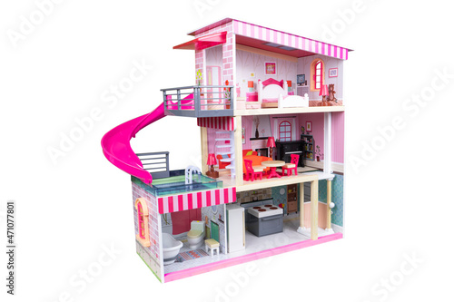 House of dolls with furniture isolated on white background. Furnished pink doll house isolated. Dollhouse. House construction with kitchen bedroom bathroom and pool interior photo