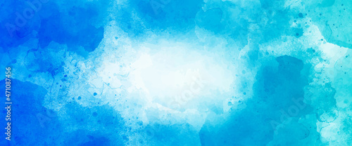 Colorful bright ink and watercolor textures on blue paper background.