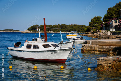 White fishing boat is moored in a harbour in Croatia