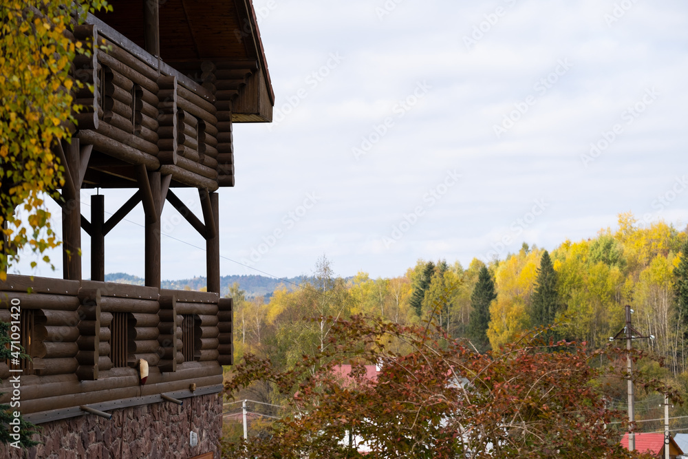 Autumn forest and mountain view from wooden terrace.