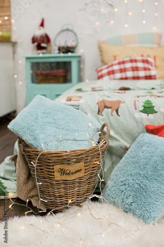 Home decor at a bedroom with fluffy pillows and christmas lights
