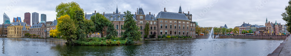 Panorama image of the Hofvijver in The Hague during the blue hour with behind the Parliament buildings and the Mauritshuis, the skyline of The Hague