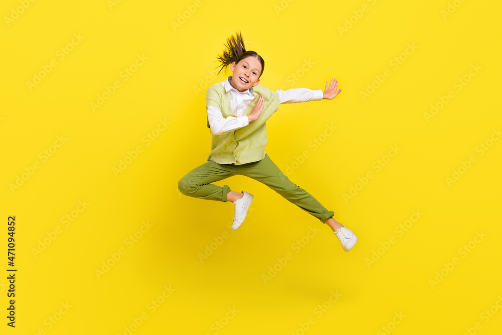 Full length body size view of attractive funny cheerful girl jumping dancing isolated on bright yellow color background Full length body size view of attractive funny cheerful girl jumping dancing isolated on bright yellow color background
