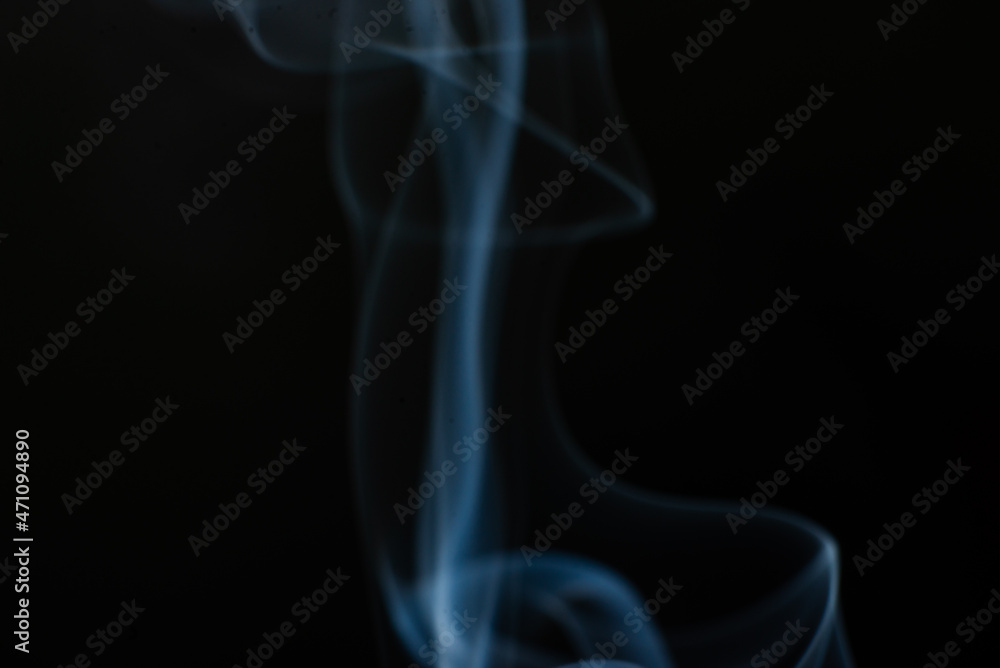 Abstract trickle of smoke on a black background.