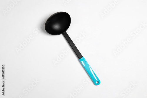 Black plastic soup ladle isolated on white background. The big black serving spoon.High-resolution photo.