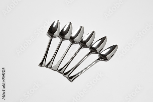 Collection of Stainless steel glossy metal kitchen spoons isolated on white background. High-resolution photo.Mock up
