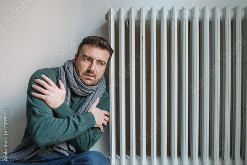 Fototapeta Man suffering cold at home and problem with house heating