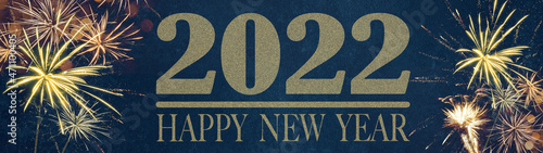 HAPPY NEW YEAR 2022 - Festive silvester New Year's Eve Party background panorama greeting card banner long - Golden fireworks in the dark blue night. © Corri Seizinger