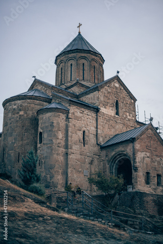 Ancient stone monastery in Georgia. Ancient church of dark stone on the hill. Old architecture, historical heritage