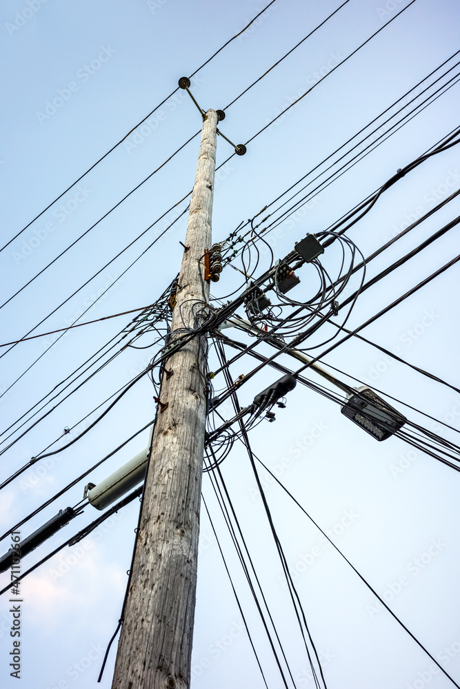 Pole with power cables and communication lines Pole with power cables and communication lines