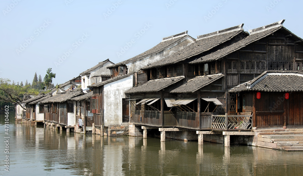Wuzhen Water Town, Zhejiang Province, China. Traditional wooden houses beside a canal in the old Chinese town of Wuzhen. Wuzhen Canal Town is also known as the Venice of the East. Wuzhen Water Town, Zhejiang Province, China. Traditional wooden houses beside a canal in the old Chinese town of Wuzhen. Wuzhen Canal Town is also known as the Venice of the East.