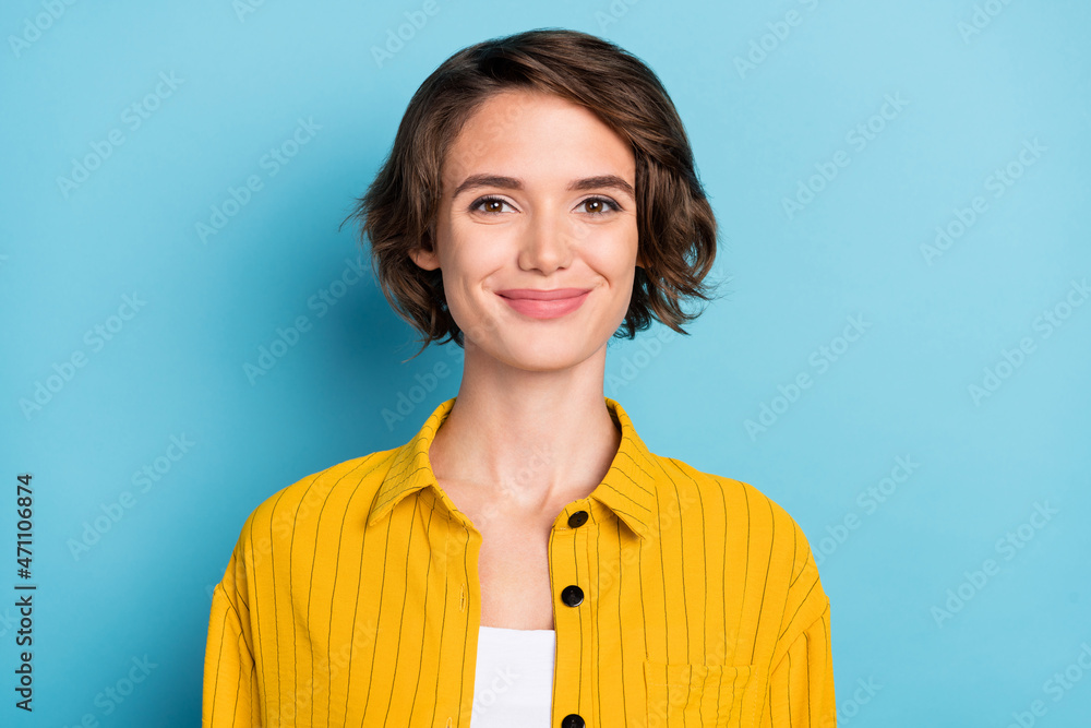 Photo of lovely cute cheerful lady bob hairstyle look camera wear yellow striped shirt isolated blue color background Photo of lovely cute cheerful lady bob hairstyle look camera wear yellow striped shirt isolated blue color background