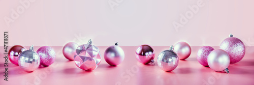 Pink Christmas tree balls on pink background, Christmas and New Year holiday banner