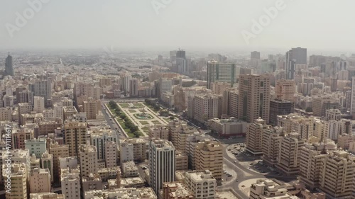 Aerial view Sharjah UAE. Urban cityscape in the desert with high-rise buildings by road cars. With new Arabic architecture. photo