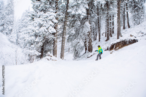 man snowboarder at winter forest