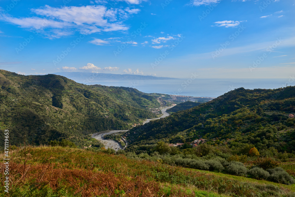 the Savoca stream runs through the valley and flows into the Ionian sea of the Strait of Messina on a beautiful sunny day in Autumn