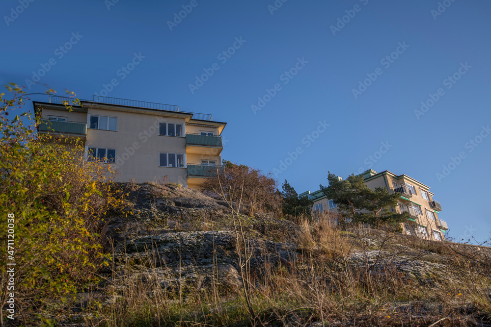 Functionalist style of apartment houses and view point at a wood promenade with benches and trees at the cliff water front in the district Marieberg a sunny color full autumn day in Stockholm Functionalist style of apartment houses and view point at a wood promenade with benches and trees at the cliff water front in the district Marieberg a sunny color full autumn day in Stockholm