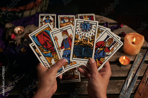 Close-up of a fortune teller reading tarot cards
