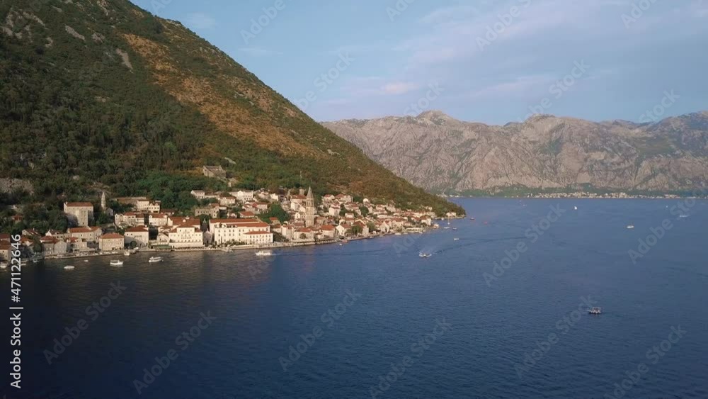Drone approaching the beautiful town Perast and passing boats in Boka Kotorska bay, Montenegro Drone approaching the beautiful town Perast and passing boats in Boka Kotorska bay, Montenegro