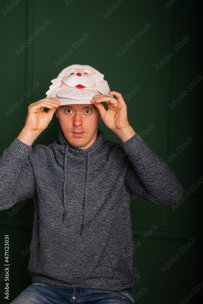 a tall man in a hare hat on a green background isolated for the New Year and Christmas 2022 a tall man in a hare hat on a green background isolated for the New Year and Christmas 2022