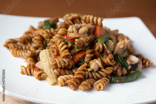 Spicy stir-fried macaroni with basil leaves