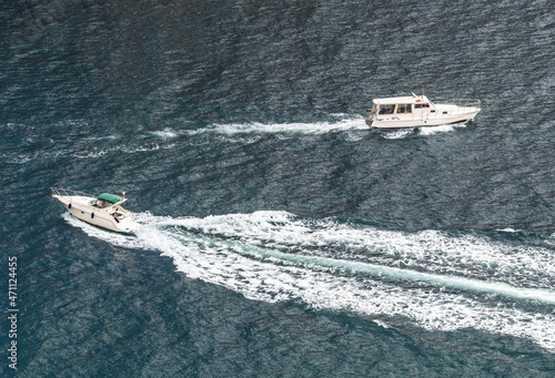 Top aerial view of two opposite speed and passenger boats with splashes on sea water © lilkin