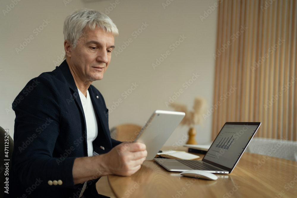 An aged man works in the evening at the workplace. Financier message to client on laptop. The economist makes a company report. The programmer creates projects online. An aged man works in the evening at the workplace. Financier message to client on laptop. The economist makes a company report. The programmer creates projects online.